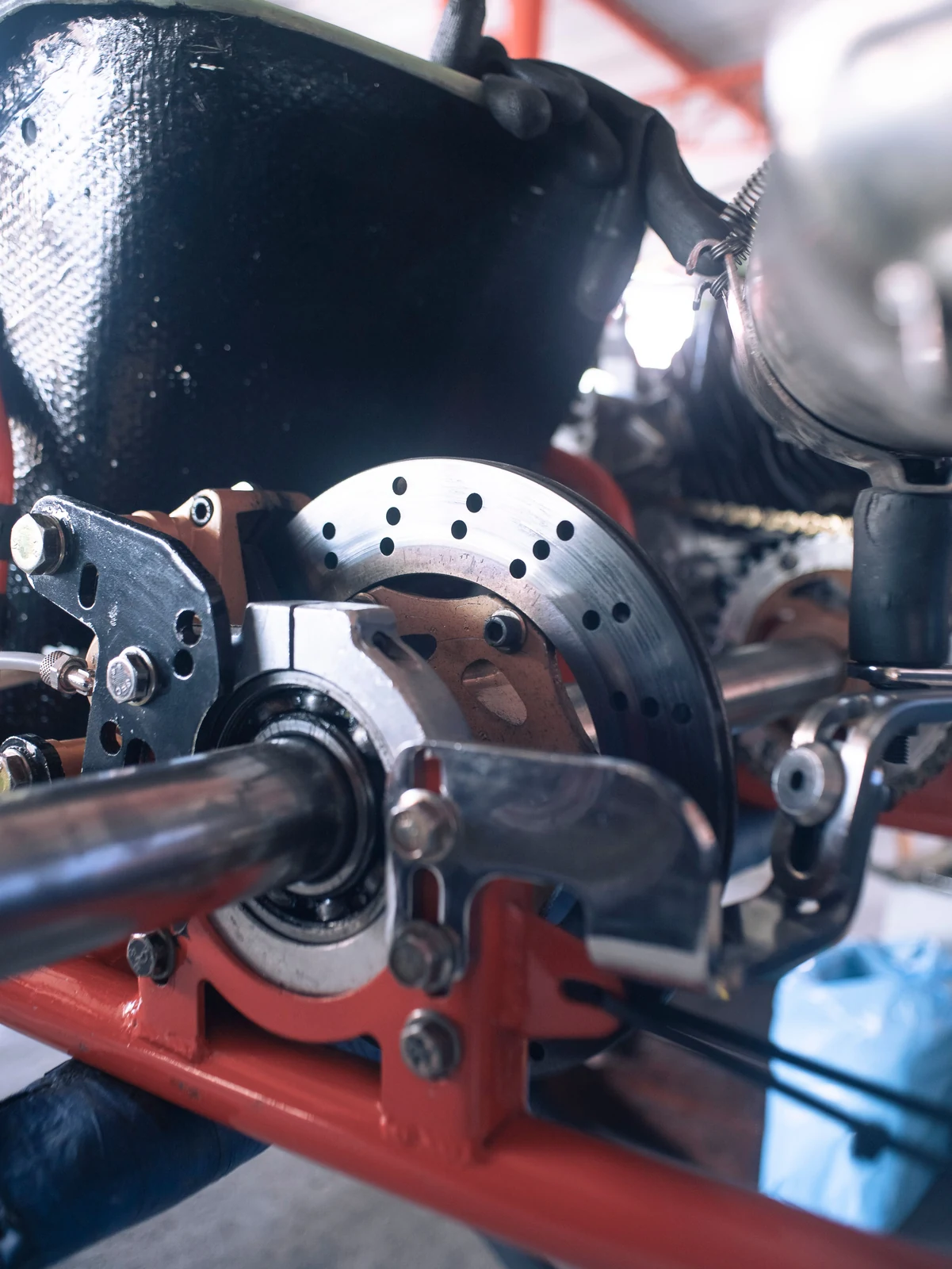 Close-up of a disc-brake mechanical assembly used for friction-material qualification.