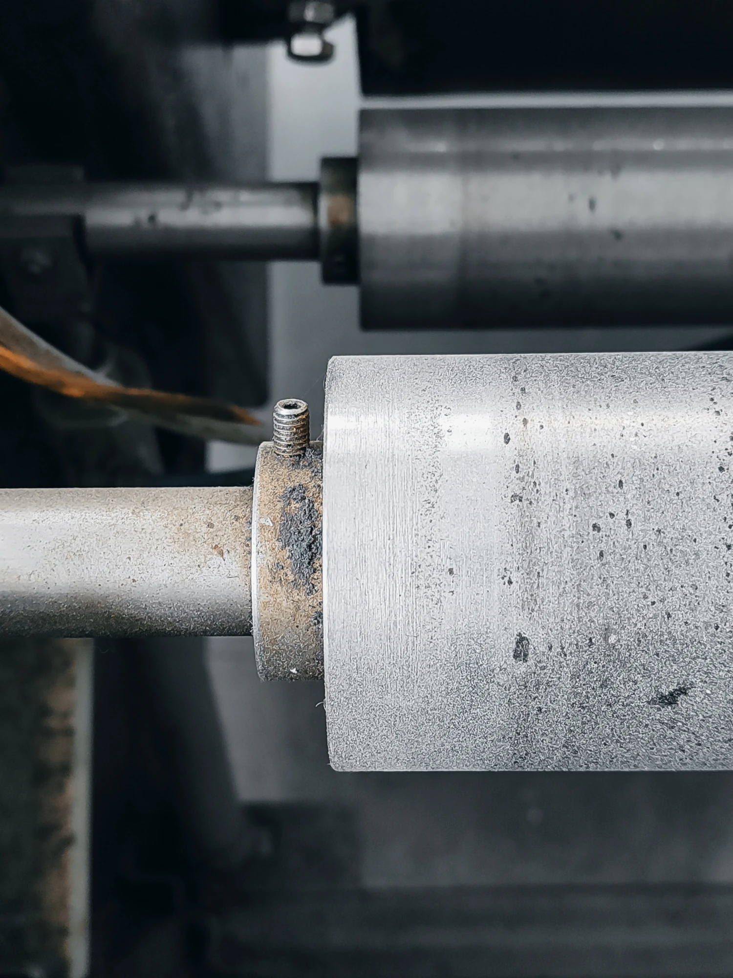 Close-up of industrial metal rollers used for flexible graphite sheet density and compressibility.
