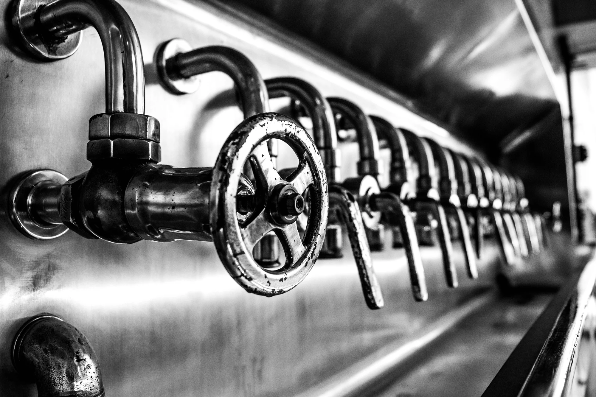 Industrial valve handles and pipework used for packing adjustment and replacement.