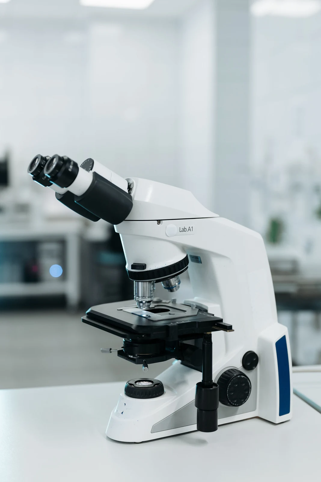Modern laboratory microscope used for particle-shape and morphology inspection.