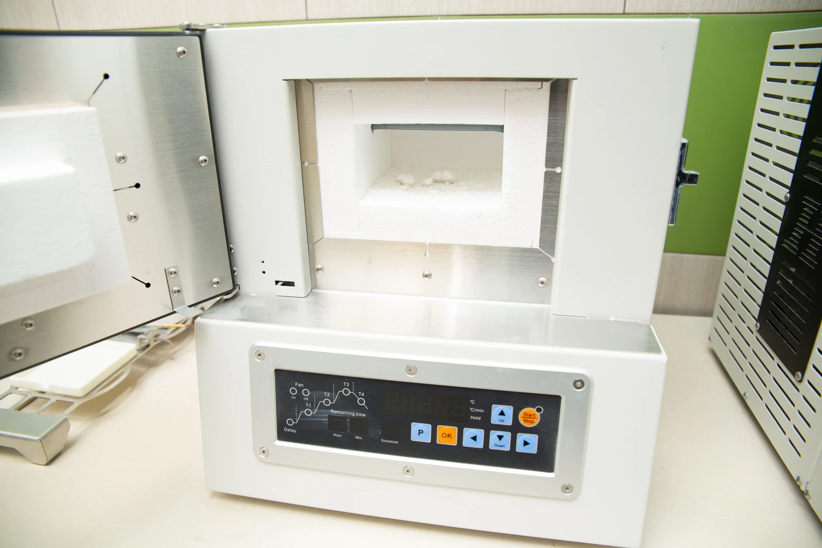 Modern electric laboratory oven used for expandable graphite expansion testing.