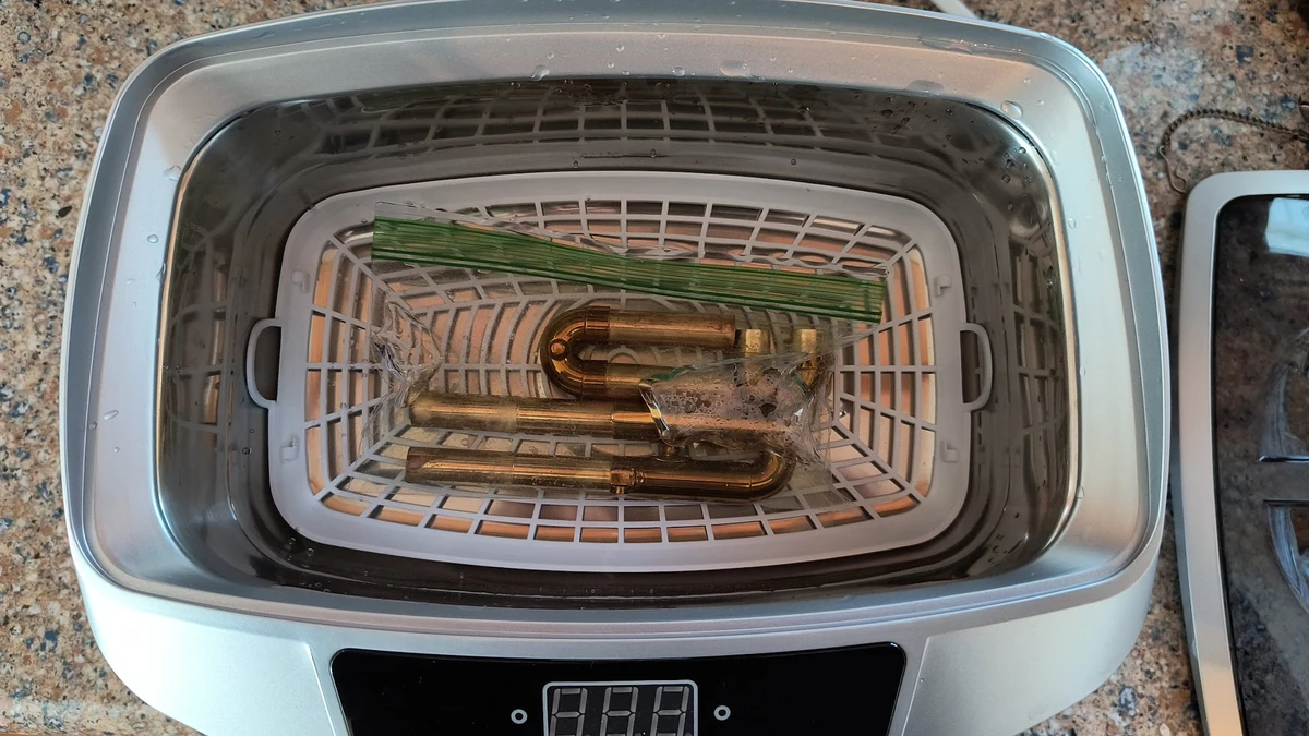 Ultrasonic cleaner used for reusable vacuum-furnace fixtures.